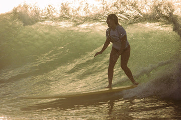 A Girl surfing in Malibu