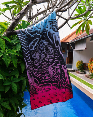 A Happy Faced Towel Hangs from a tree beside a pool