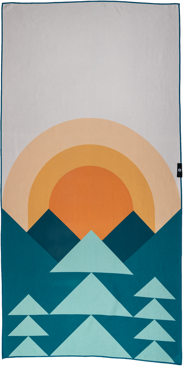 A towel featuring a minimalist geometric design of mountains and a sun. The lower half showcases a series of teal and light blue triangular shapes resembling mountains, while the upper half depicts a warm orange and yellow gradient sun rising or setting behind the peaks. The background is a light gray, providing contrast to the vibrant colors of the sun and mountains. The design is clean, modern, and inspired by nature, evoking a peaceful outdoor landscape.