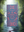 Patterned towel with red and blue design in a forest setting