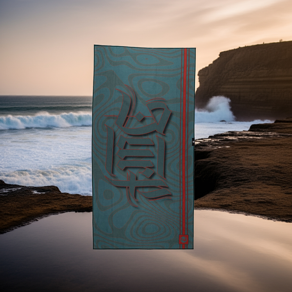 Towel with tribal design that says SURF in front of a beach scene with waves and cliffs.