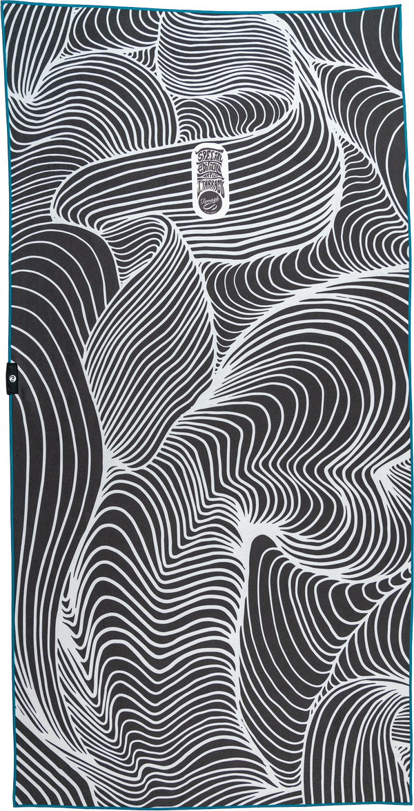 A towel with a black and white design featuring flowing, abstract lines that create a hypnotic, wave-like pattern across the entire surface. The organic curves interweave, creating a mesmerizing effect. At the center, there is a small, oval emblem that reads "Special Edition Artist Series" in stylized text. The overall aesthetic is bold, minimalistic, and visually dynamic, giving the towel a modern, artistic appeal.