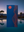 Blue towel with red abstract desert mountain and sunset design by a pool at dusk
