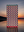The Happy Faced Towel - Just One More - floating above a lake at sundown