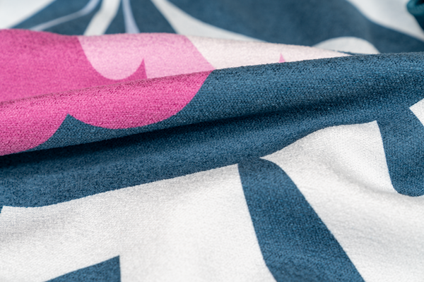 Close-up of the towel fabric, showcasing vibrant pink and teal hues with sharp details and smooth texture, emphasizing the high-quality print and plush material.