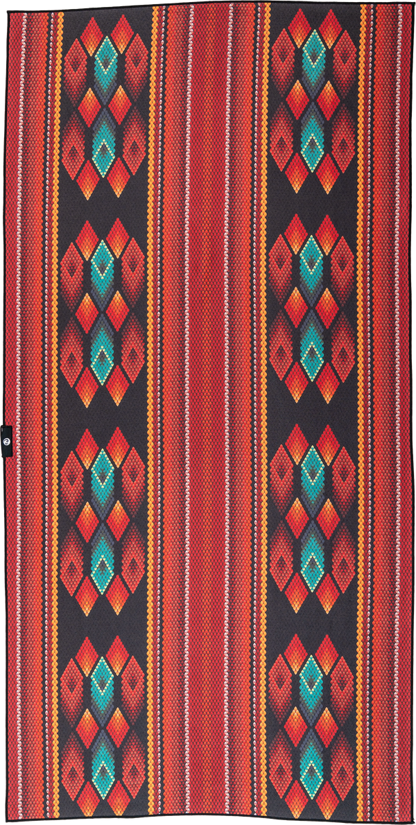 A towel with a bold geometric design featuring diamond patterns in vibrant shades of red, orange, and teal on a black background. The repeating diamond shapes are accentuated by smaller colorful details, creating a visually striking and dynamic look.