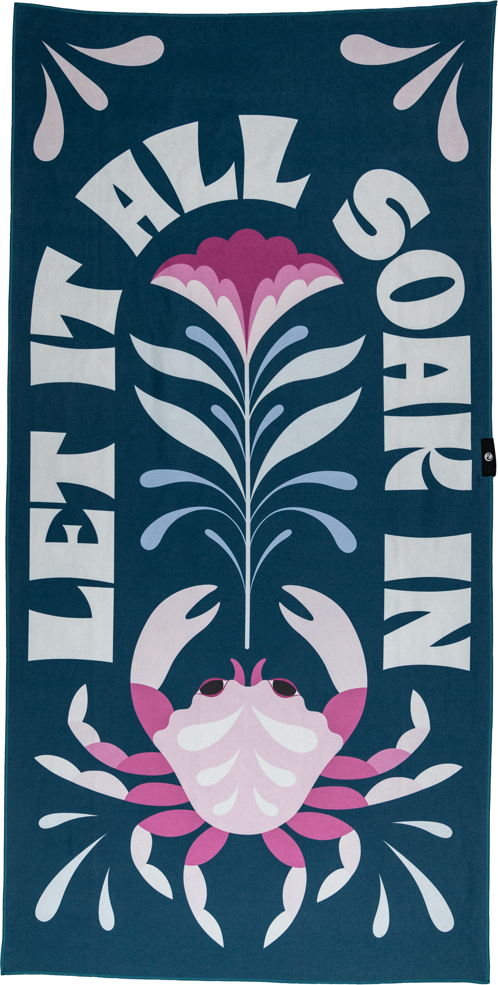 A playful towel with a pink crab, flower, and water droplets, framed by the bold text "LET IT ALL SOAK IN." The dark teal background and bright accents create a fun, vibrant beach vibe.