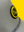 Close up view of the grey happy faced cap with a view of the rubber yellow and black logo on a yellow background