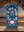 Decorative towel with floral and crab design in front of a stone archway with a beach view.