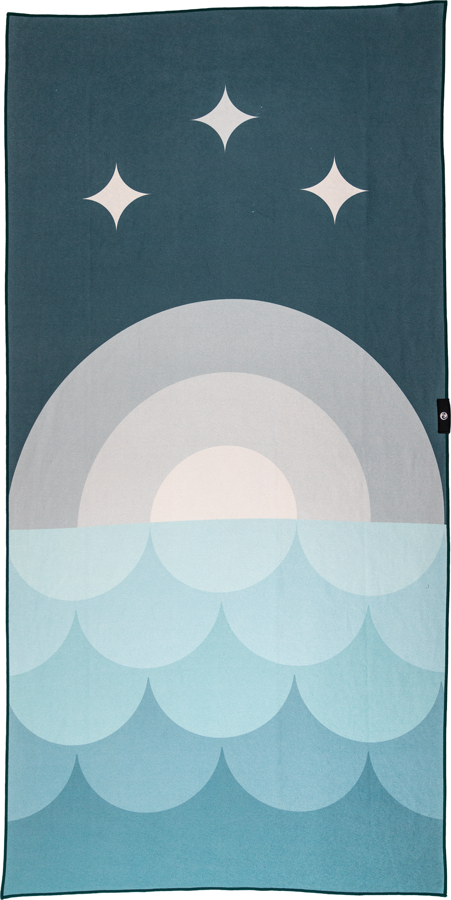 A Happy Faced towel featuring an artist-designed pattern with a semi-circular moonrise over a stylized ocean wave, predominantly in shades of blue.
