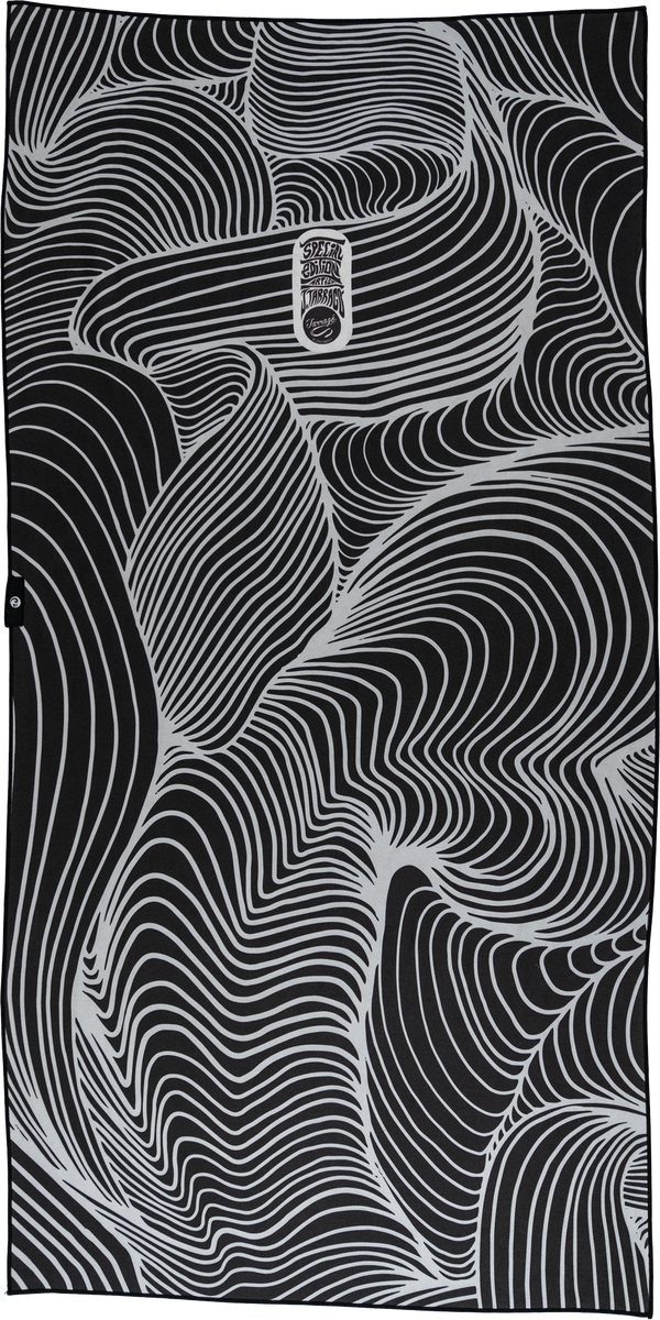 A towel with a black and white design featuring flowing, abstract lines that create a hypnotic, wave-like pattern across the entire surface. The organic curves interweave, creating a mesmerizing effect. At the center, there is a small, oval emblem that reads "Special Edition Artist Series" in stylized text. The overall aesthetic is bold, minimalistic, and visually dynamic, giving the towel a modern, artistic appeal.