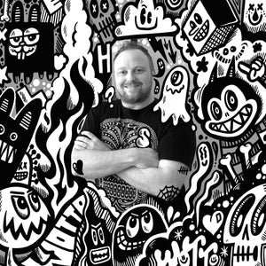 Artist Profile, man standing with arms crossed surrounded by cartoon creatures in black and white. An image of the artist Wotto for Happy Faced Towels