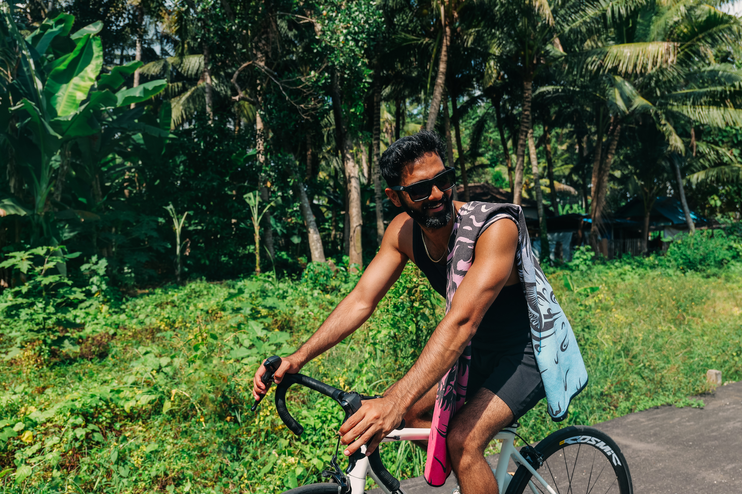 Cyclist riding outdoors with a lightweight towel on the bike