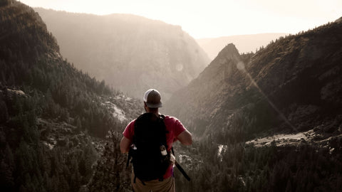 Hiker looking out across a mountain valley during a camping trip