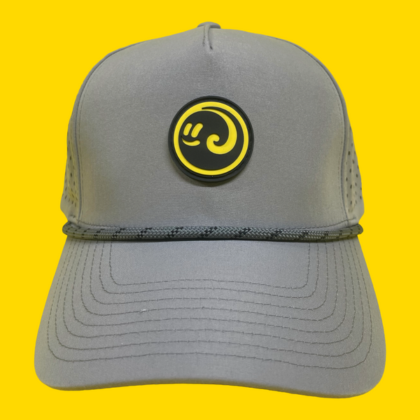 Front view of the gray Happy Faced cap with a the yellow and black logo on a yellow background