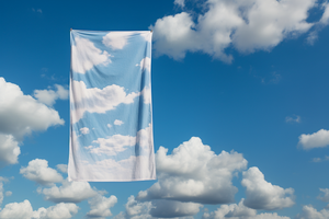 A Towel with a cloud print on it floats in the sky with clouds surrounding it for Happy Faced Towels